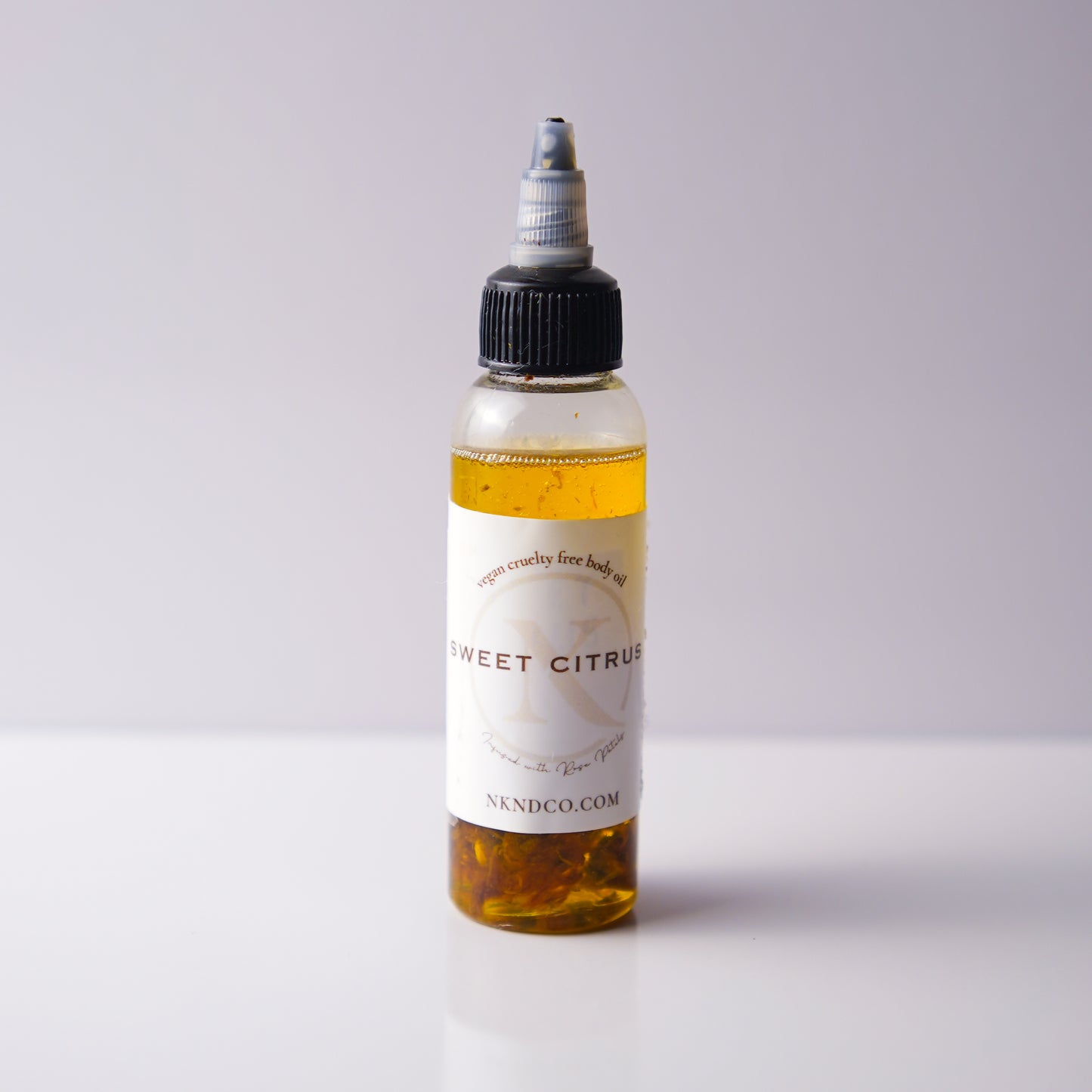 Bottle of 'Sweet Citrus' oil with a white label on a light gray background