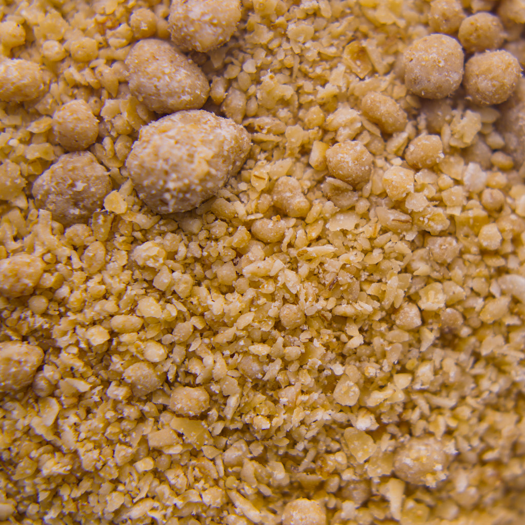 Close-up of "Awele" Oatmeal Calming Scrub texture and yellowish-brown color