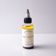 Bottle of 'Rosey Lavender' body oil on a white background