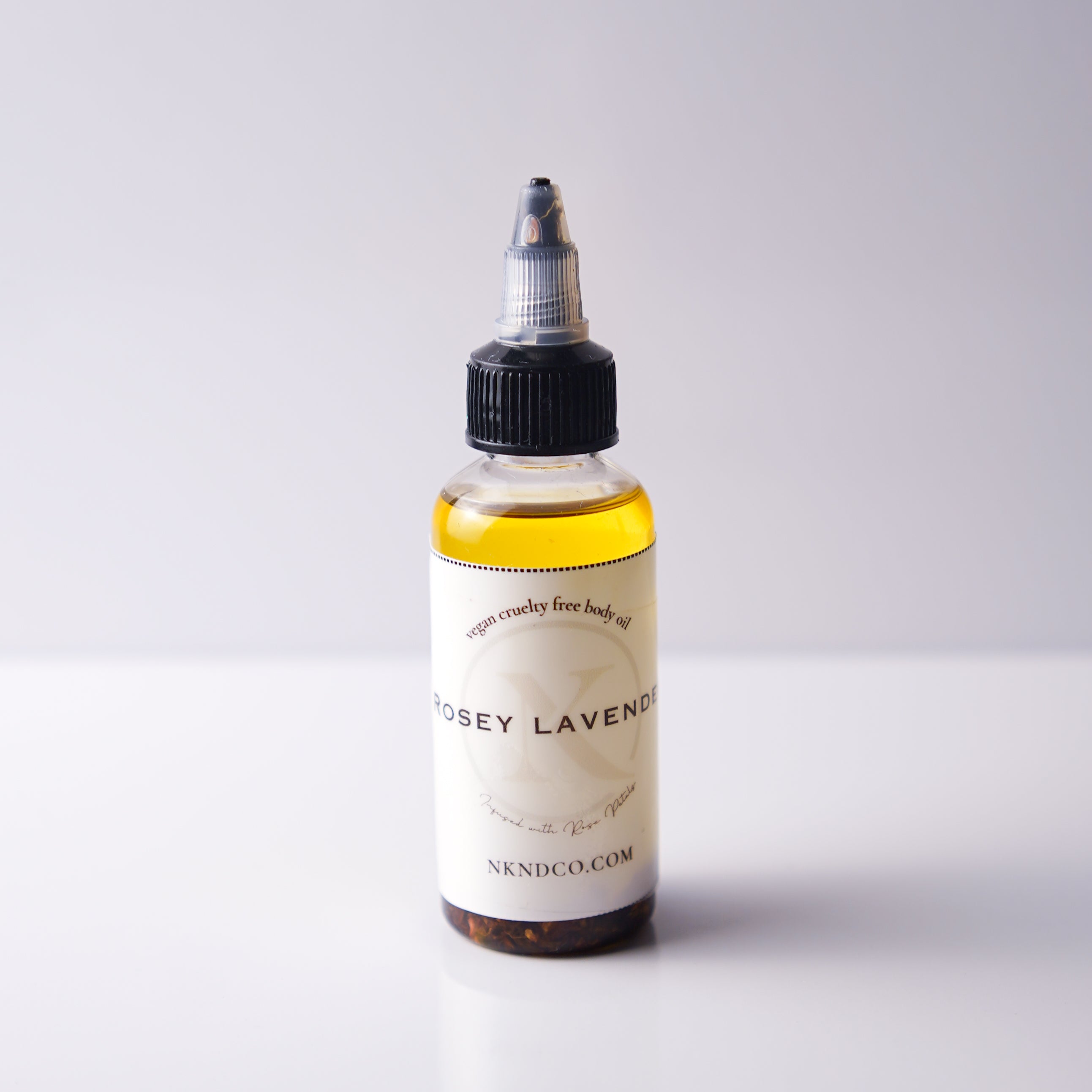 Bottle of 'Rosey Lavender' body oil on a white background