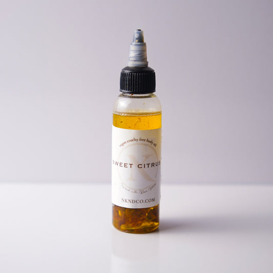 Bottle of 'Sweet Citrus' oil with a white label on a light gray background