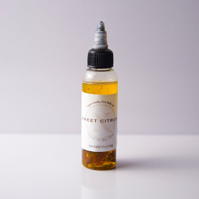 Bottle of 'Sweet Citrus' oil with a white label on a light gray background