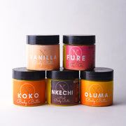 Five jars of Koko Body Butter in different flavors on a white background