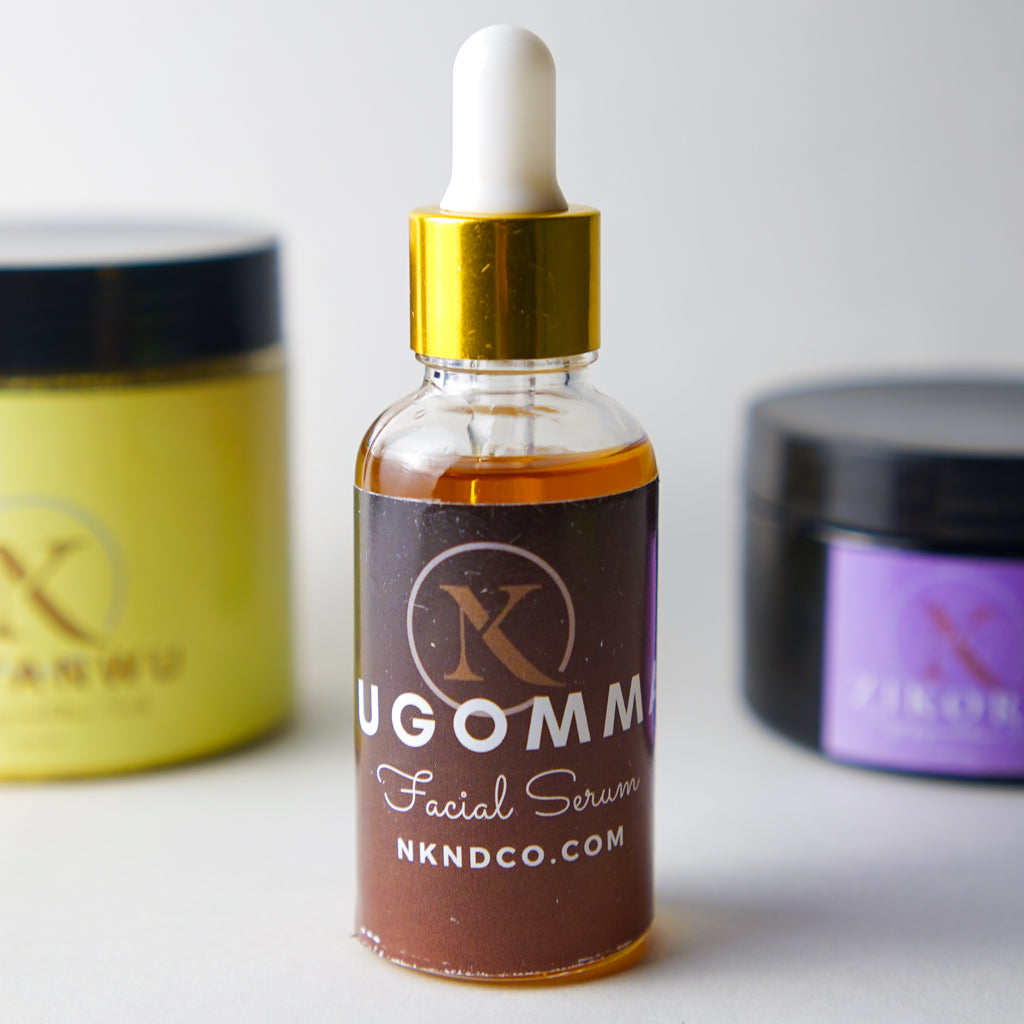Facial serum bottle with dropper labeled 'UGOMM' on a white background
