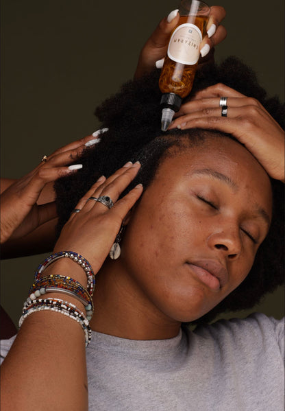 image of a woman having "Chizaram" Anti-Itch Serum applied to her hair